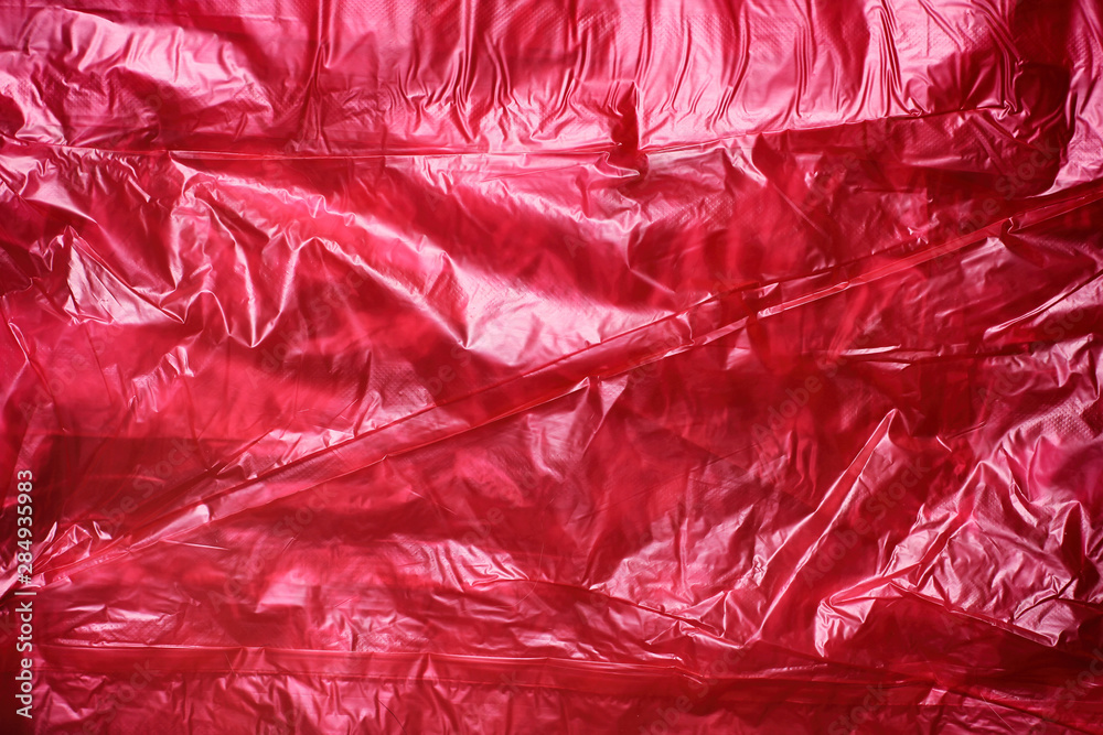 Obraz premium Red crumpled plastic garbage bag texture background. Waste recycle concept. Pattern of materials. 