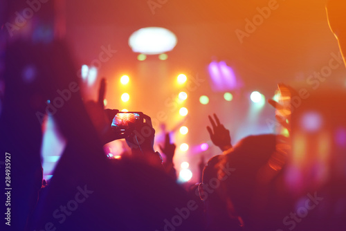 silhouettes of , Fun concert party rock disco light background.