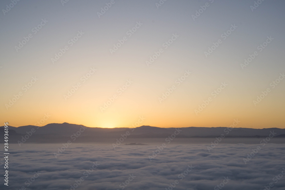 start of sunrise in the mountains and sea of clouds