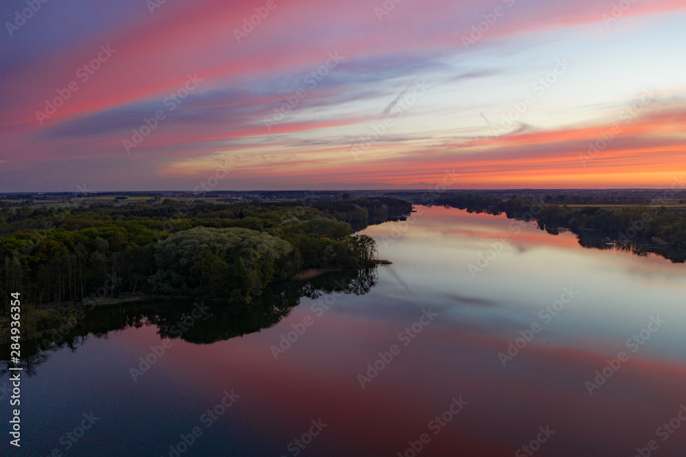 Aerial drone photography of a lake landscape during sunset. Beautiful and calm rural landscape. 