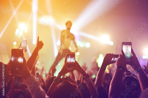 silhouettes of  , Fun concert party rock disco light background.