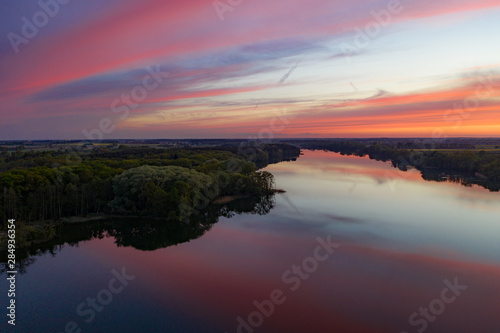 Aerial drone photography of a lake landscape during sunset. Beautiful and calm rural landscape. 