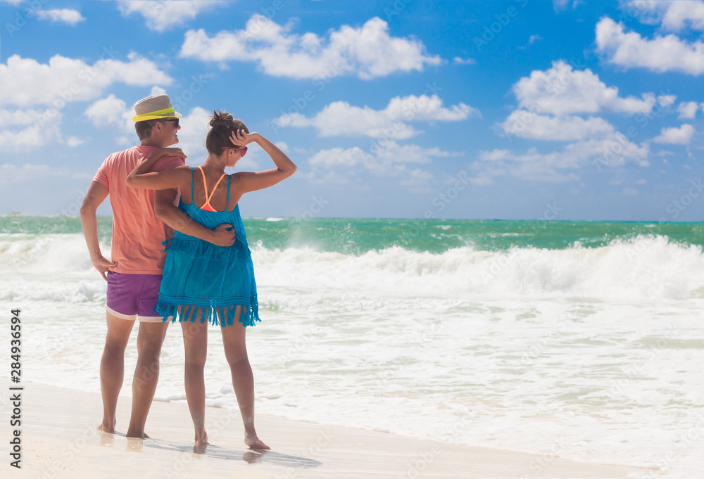 Beach couple walking on romantic travel honeymoon vacation summer holidays romance. Young happy lovers, Cayo LArgo, Cuba Beach couple walking on romantic travel honeymoon vacation summer holidays romance. Young happy lovers, Cayo LArgo, Cuba