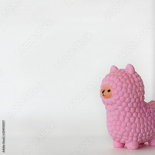 Pink small llama squishy on white empty background. Square with copy space. Isolate. Soft toy for kids, antistress.