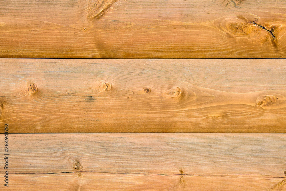 Wall of a log house. Log-house. Wall of light wood logs. Wood background.