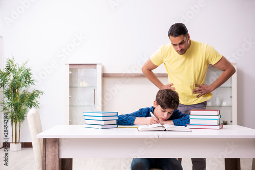 Father helping his son to prepare for school