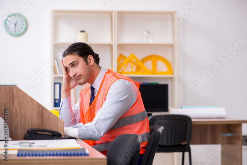 Young male architect working in the office