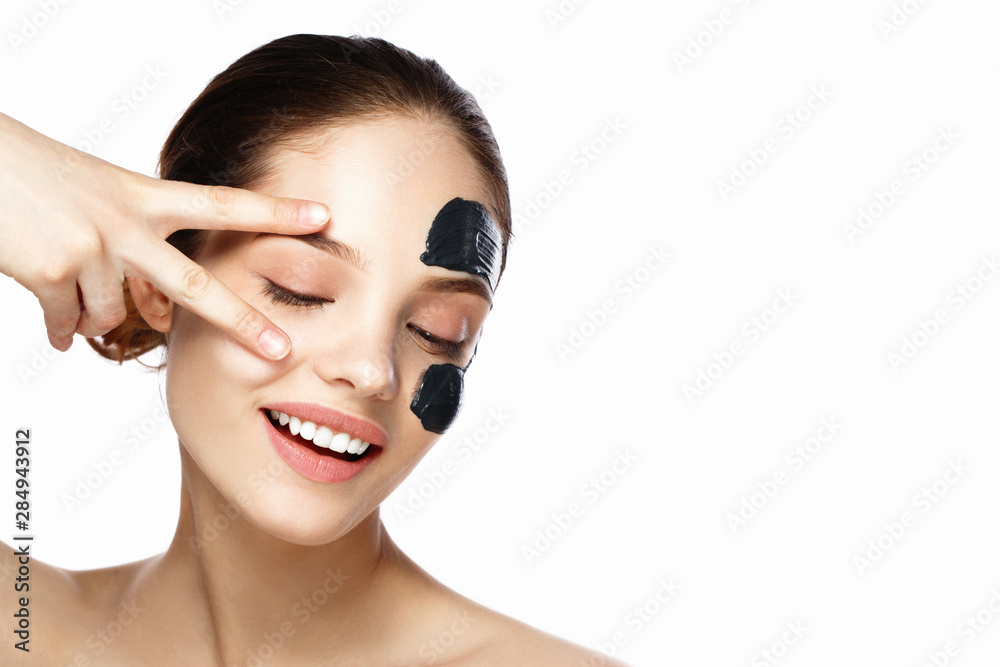 young woman applying moisturizing cream on her face. Skin care concept