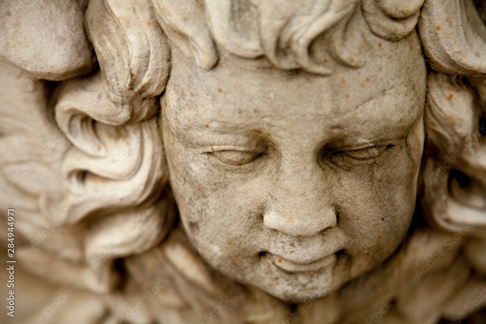 Top view of ancient statue of angel with wings. Selective focus. Top view of ancient statue of angel with wings. Selective focus.