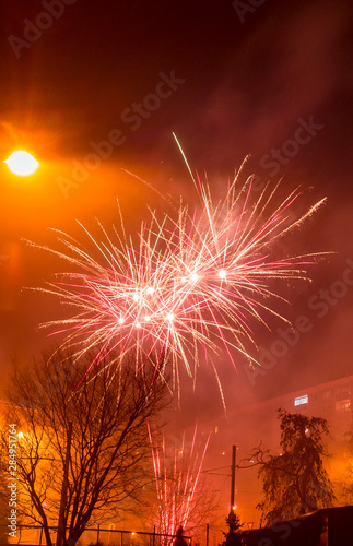 New Year's fireworks create smoke over houses on the outskirts of the city - Long exposure at night on New Year
