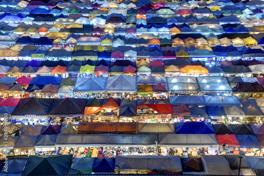 Fototapeta premium Market with colorful tents in sunset time. This is place in Thailand call Train Market