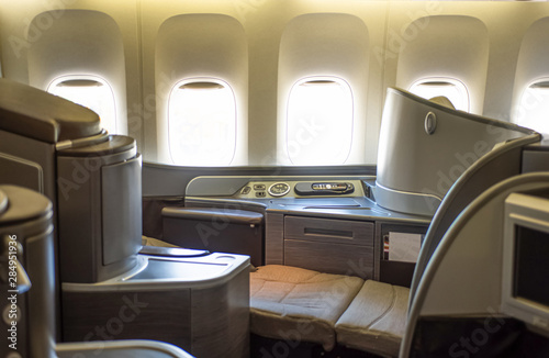 First business class seat in airplane. Horizontal position of seat bed.