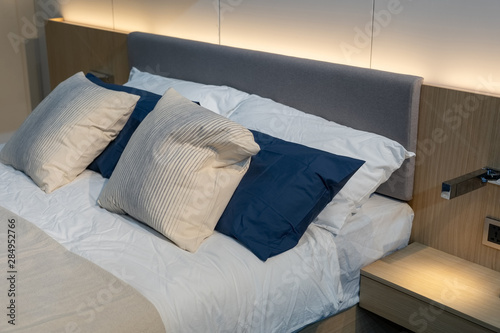 White and black pillows on a bed