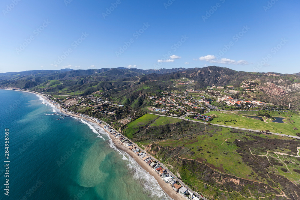Aerial view of shoreline homes coastal mountains near Los Angeles and Santa Monica in Malibu, California.  