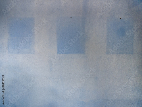 Blue-white wall with outlines of removed images