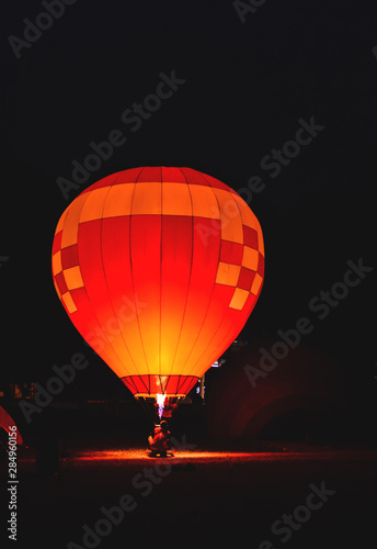 The team is preparing a balloon with a fire to make the balloon rise.