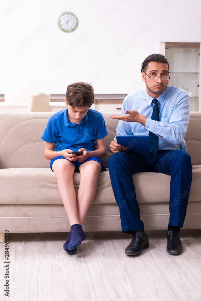 Internet addicted boy visiting male doctor