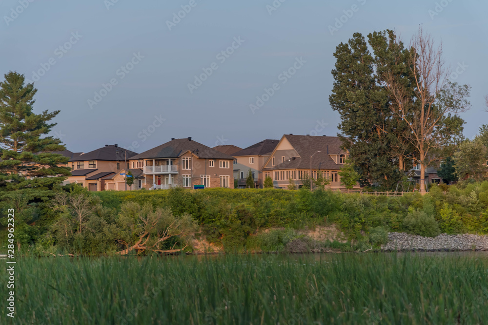 Houses between green fields in Ottawa, Canada