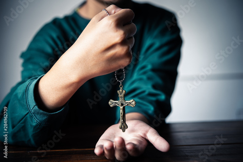 The Christian hand holds the necklace of Christ in his hand, as if he had always been with God.