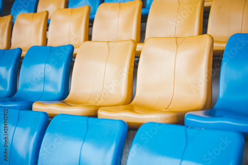Rows of plastic seats on a grandstand, chair in a stadium, sitting area for spectator