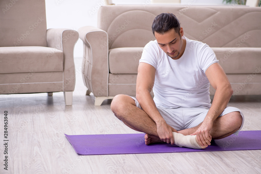 Leg injured man doing exercises at home Leg injured man doing exercises at home