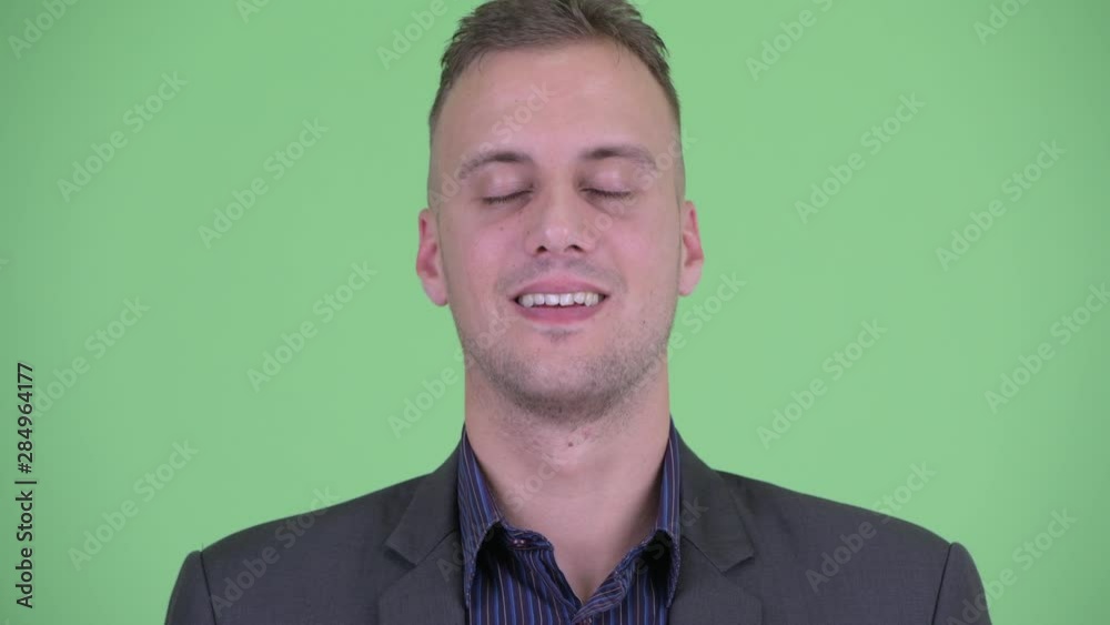 Face of happy businessman in suit relaxing with eyes closed Face of happy businessman in suit relaxing with eyes closed