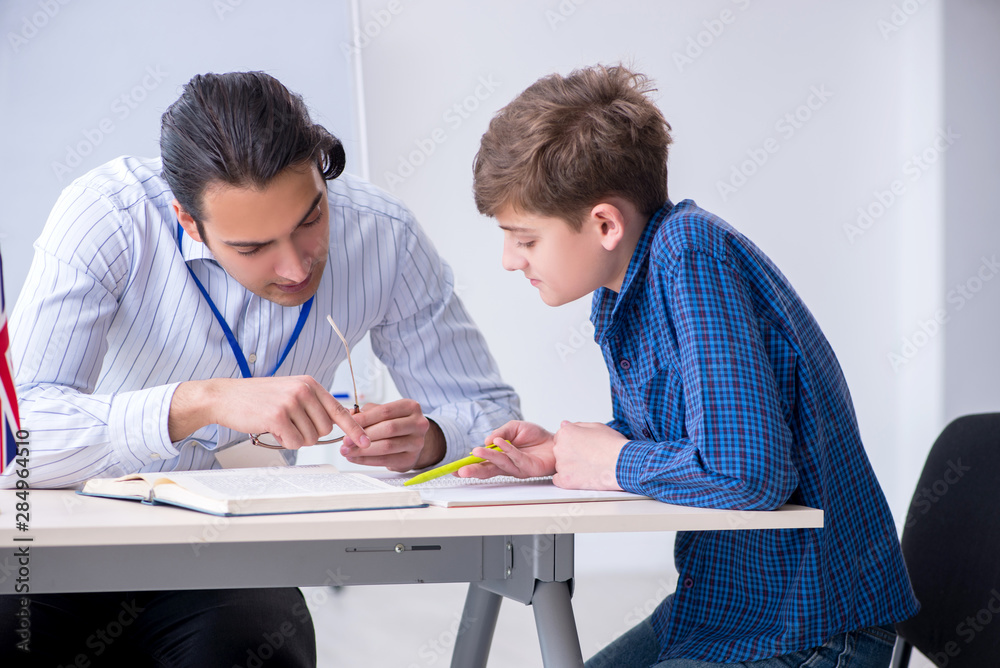 Male english teacher and boy in the classroom Male english teacher and boy in the classroom