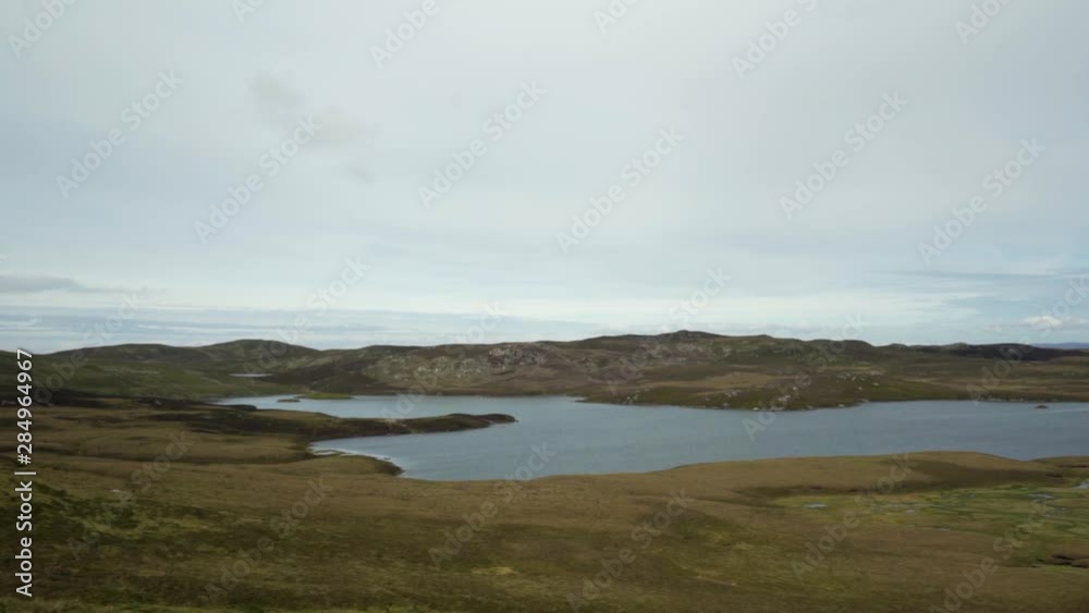 Still day in the Scottish Highlands showing distant hills and a large open loch Still day in the Scottish Highlands showing distant hills and a large open loch