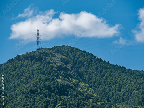 Power cable on mountain in Fukuoka prefecture, JAPAN. Power cable has been connected in the transmission steel towers.