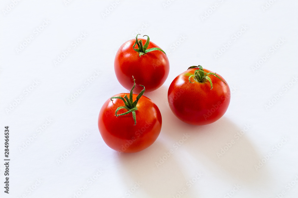 small red cherry tomatoes on white background small red cherry tomatoes on white background