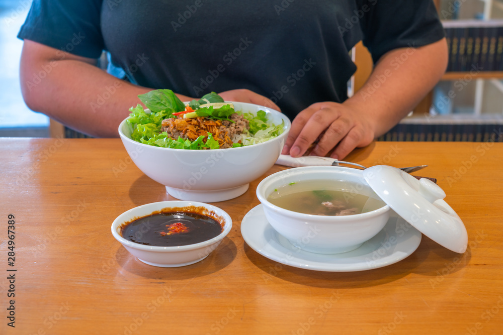 Tasty pork noodle soup and fresh vegetables in Vietnamese restaurant Tasty pork noodle soup and fresh vegetables in Vietnamese restaurant