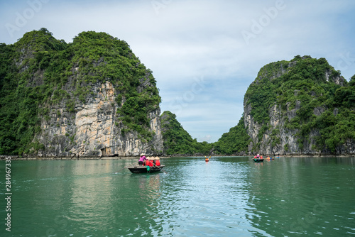 Halong bay in Vietnam, UNESCO World Heritage Site, with tourist rowing boats