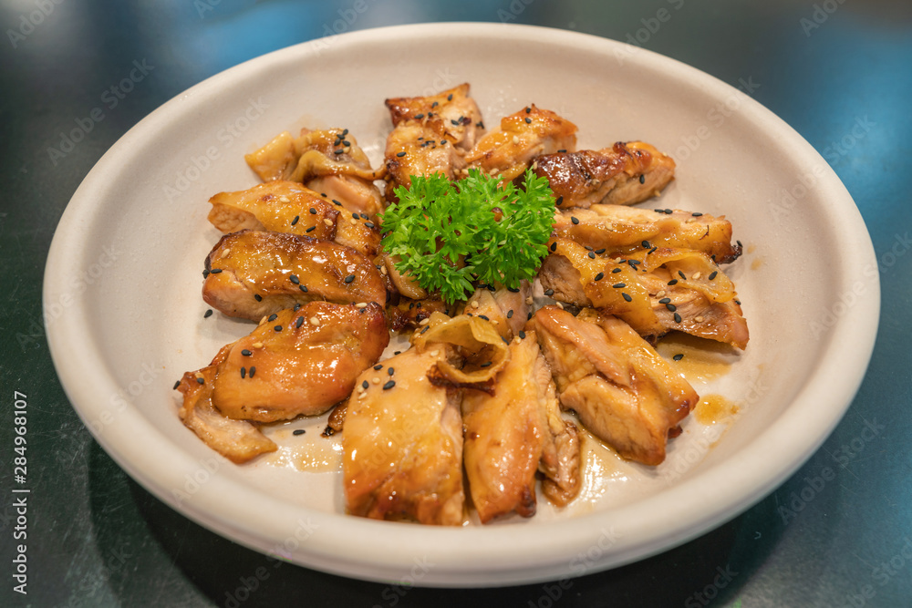 Delicious and well-decorated dish of grilled chicken in Korean style Delicious and well-decorated dish of grilled chicken in Korean style