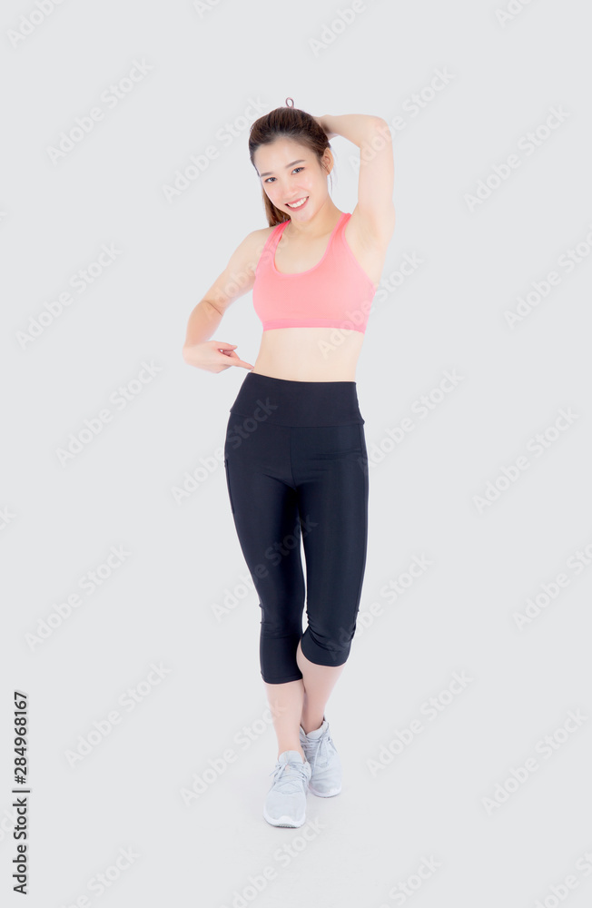 beautiful portrait asian woman in sport clothing pointing waist with satisfied and confident isolated on white background, girl asia have shape and wellness, exercise for fit with health concept. beautiful portrait asian woman in sport clothing pointing waist with satisfied and confident isolated on white background, girl asia have shape and wellness, exercise for fit with health concept.