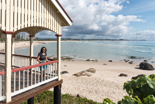 Female baby boomer in a wooden shelter at Kirra Beach, Gold Coast, Queensland, Australia. photo