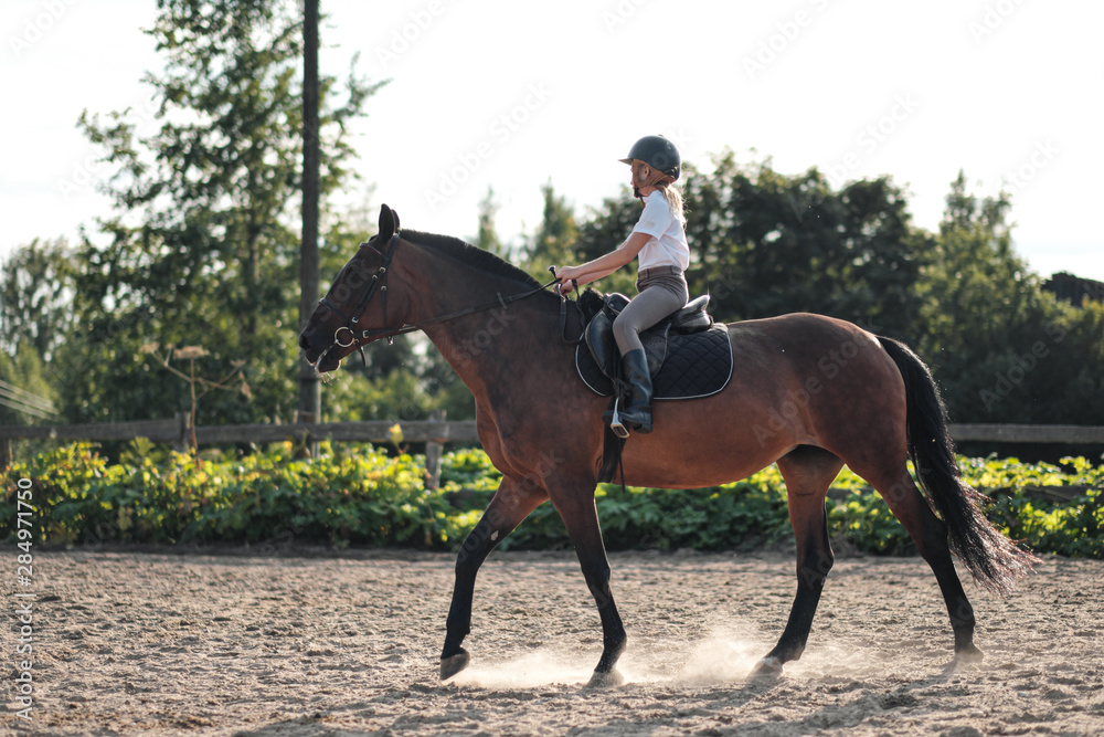 Girl teenager jockey trains on the field and at the hippodrome. Girl teenager jockey trains on the field and at the hippodrome.