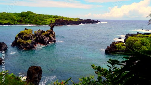 Beautiful, blue Keawaiki Bay and Black Sand Beach & lava rocks on Road to Hana, Maui, Hawaii, wide static Pacific ocean waves, 4k ProRezHQ.mov photo