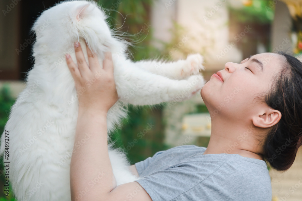 Asian beautiful woman cuddling carry white persian cat Long hair on nature blurred background for lifestyle in home with friendship cuddling image Asian beautiful woman cuddling carry white persian cat Long hair on nature blurred background for lifestyle in home with friendship cuddling image