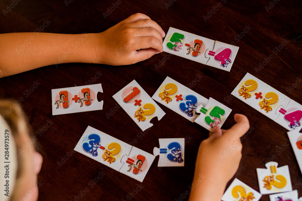 Kids are playing. Educational games. A child in kindergarten. The hands of a child. Maths. Cards for development.Stack of Math Flash Card.School cards with math problems Kids are playing. Educational games. A child in kindergarten. The hands of a child. Maths. Cards for development.Stack of Math Flash Card.School cards with math problems