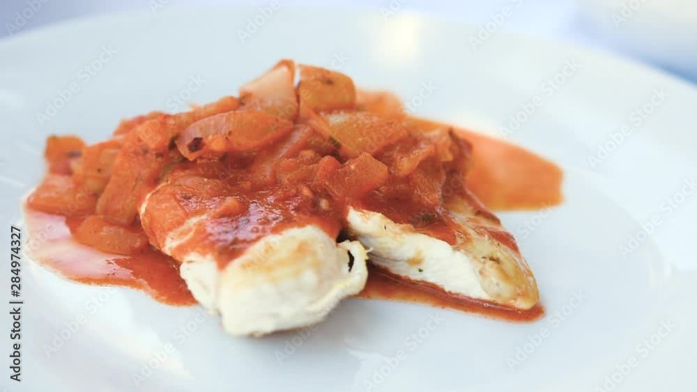 Fried chicken meat served with tomato stew and mashed potatoes. Slow motion of serving food. Fried chicken meat served with tomato stew and mashed potatoes. Slow motion of serving food.