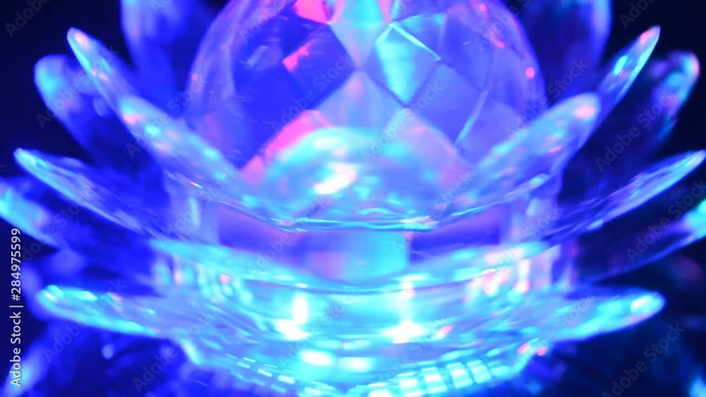 Close-up of a multi-colored rotating lamp. Lotus lamp. Close-up of a multi-colored rotating lamp. Lotus lamp.