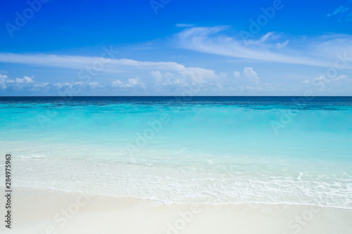 Sea view from beautiful tropical beach with clear water, blue sky and white sand in Maldives island, Indian Ocean. Summer, travel and holiday vacation background concept.