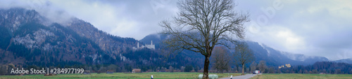 Beautiful view of world-famous Neuschwanstein Castle on the mountain in rainy day, southwest Bavaria, Germany 