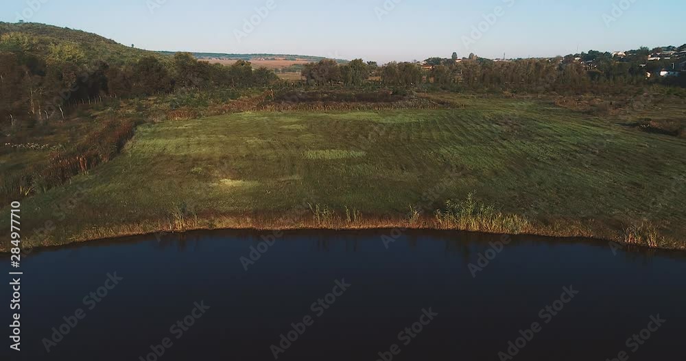 Aerial view of a river, green plain and a village. Aerial view of a river, green plain and a village.