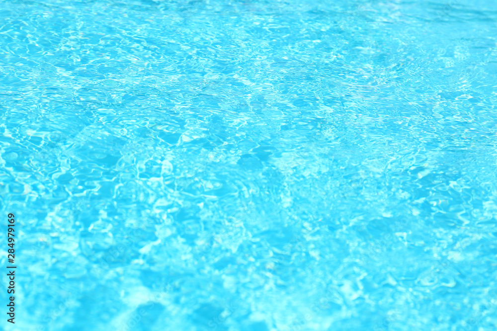 Surface of swimming pool with clean blue water, closeup