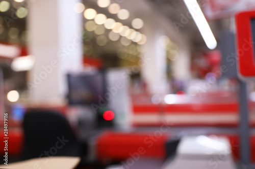 Blurred view of checkout lanes in supermarket with bokeh effect