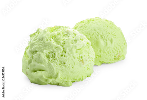 Scoops of delicious pistachio ice cream on white background