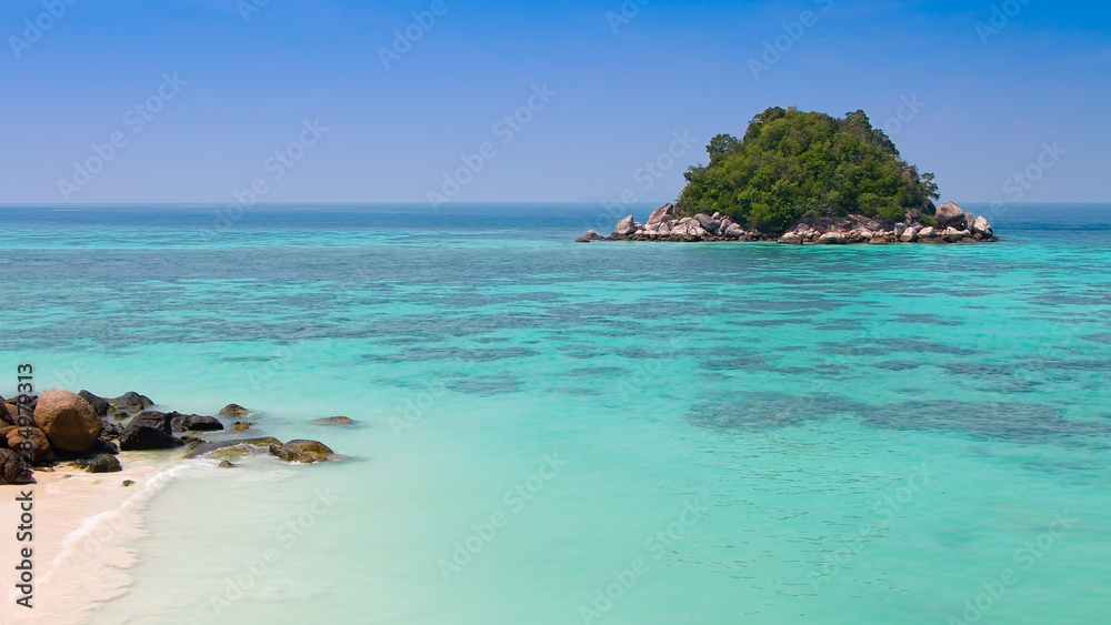Fototapeta premium Beautiful landscape of tropical island with clear water, white sand beach and blue sky in Summer. Koh Lipe, Satun, Southern of Thailand. Travel and holiday vacation background concept.