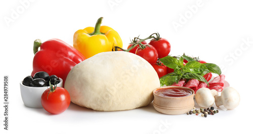 Fresh dough and ingredients for pizza on white background