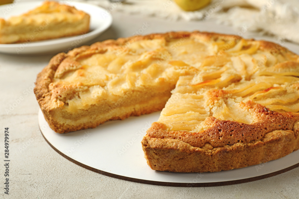 Cut delicious sweet pear tart on table, closeup Cut delicious sweet pear tart on table, closeup
